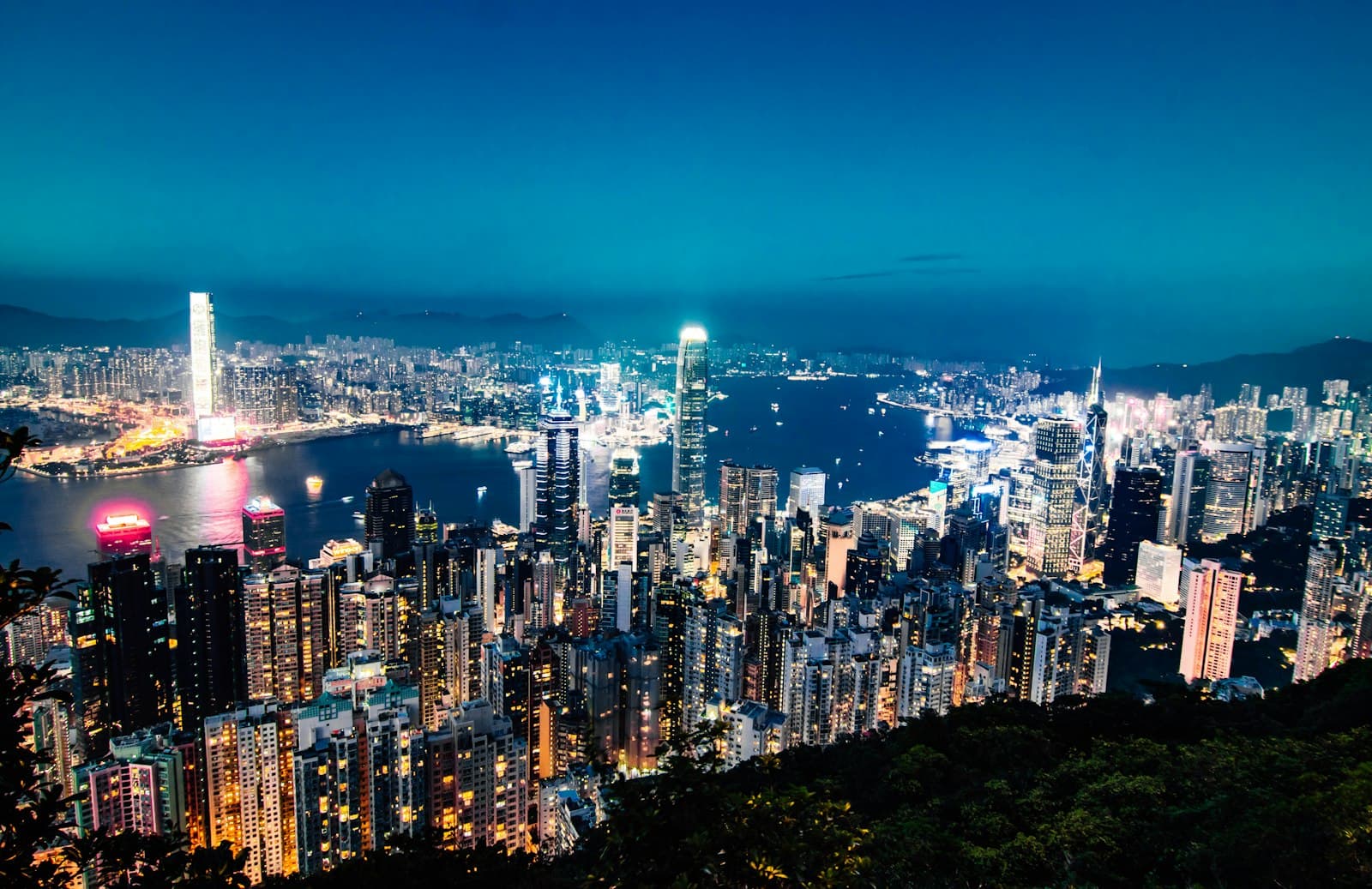 The Hong Kong skyline lit up at dusk, seen from Victoria Peak